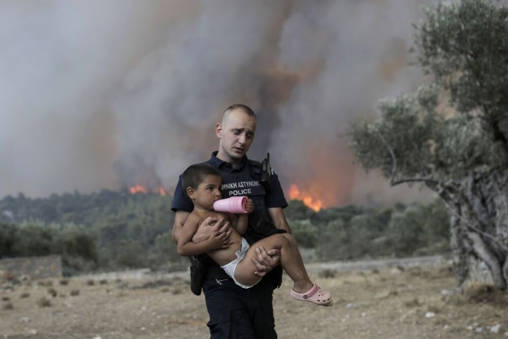 Wildfires lead to evacuations in Greece  / KOSTAS TSIRONIS