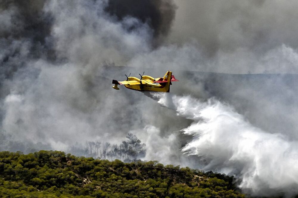 Wildfires lead to evacuations in Greece  / VASILIS PSOMAS