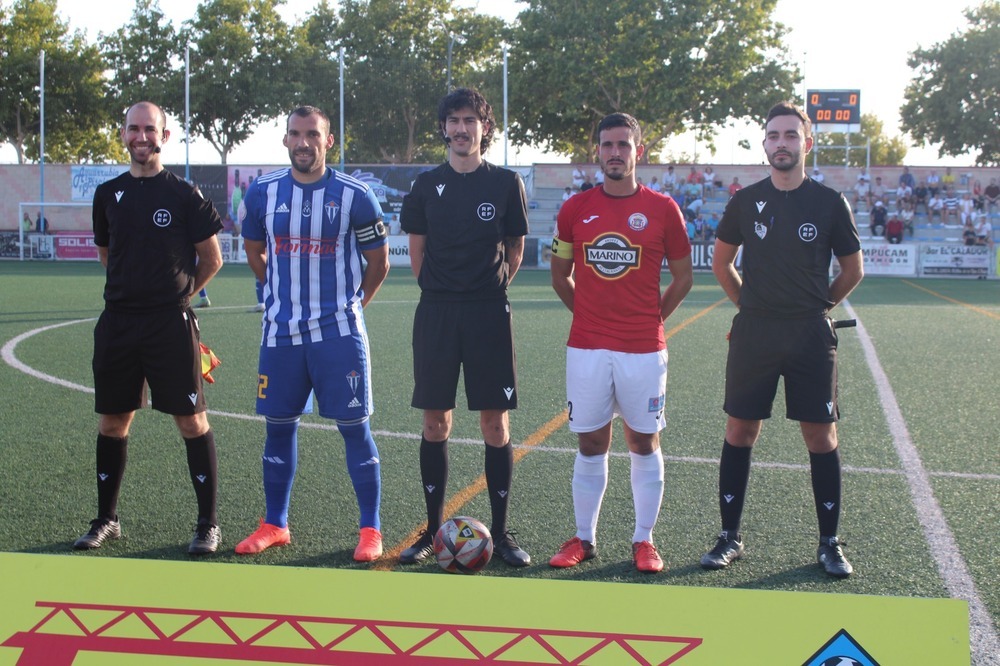 Los capitanes posan con el trío arbitral.