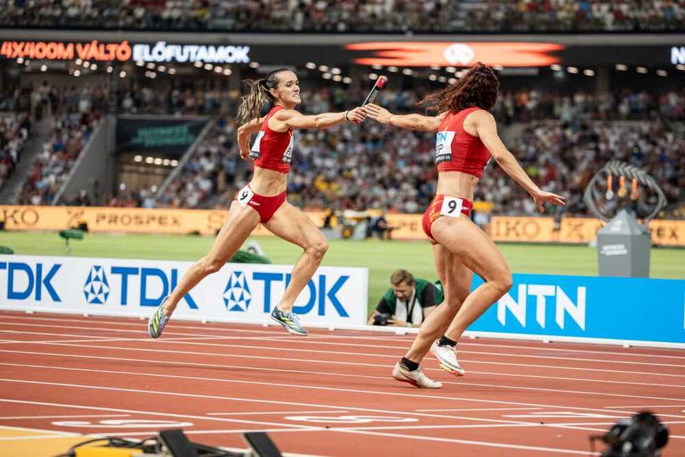 Herminia Parra entrega el testigo del relevo 4x400 en el Mundial de 2023.